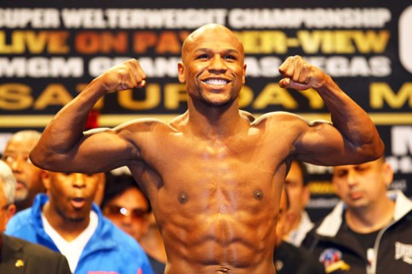 LAS VEGAS, NV - MAY 04:  Boxer Floyd Mayweather Jr. poses after weighing in at 151 pounds during the official weigh-in for his bout against WBA super welterweight champion Miguel Cotto at the MGM Grand Garden Arena on May 4, 2012 in Las Vegas, Nevada. Mayweather will challenge Cotto for his title on May 5, 2012 in Las Vegas.  (Photo by Al Bello/Getty Images)